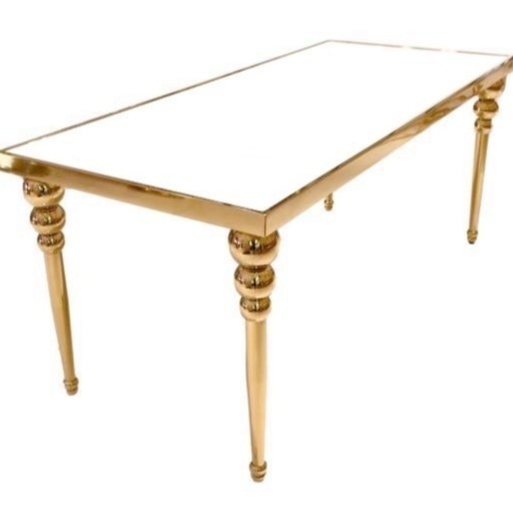 Gouden tafel met glazen blad en sierlijke poten.
